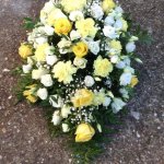 #### Casket spray in yellow and cream seasonal flowers to include carnations and roses 
 4ft £175